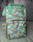 Parents Baby Backpack with rainbow and cloud pattern on a wooden surface