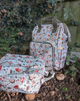Two patterned bags on the ground with a natural background