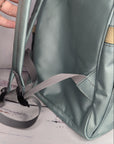 Straps of a Green Cheeks baby changing bag