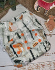 An image of cloth pocket nappies with hemp boosters neatly arranged on a flat surface. The nappies are made of soft, colorful fabric with elastic leg cuffs and snaps for adjustable sizing. The hemp boosters are slim inserts made from natural fibers, designed to enhance absorbency. This eco-friendly diapering option provides reusable and sustainable comfort for babies
