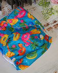 Cloth pocket nappies with hemp boosters in various vibrant colors, providing a sustainable way to keep babies comfortable and dry in blue and pink, unisex design.