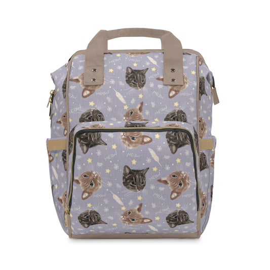 Purple baby changing backpack with adorable cat and kitten illustrations.