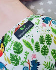 A baby wears a Green Cheeks reusable nappy.