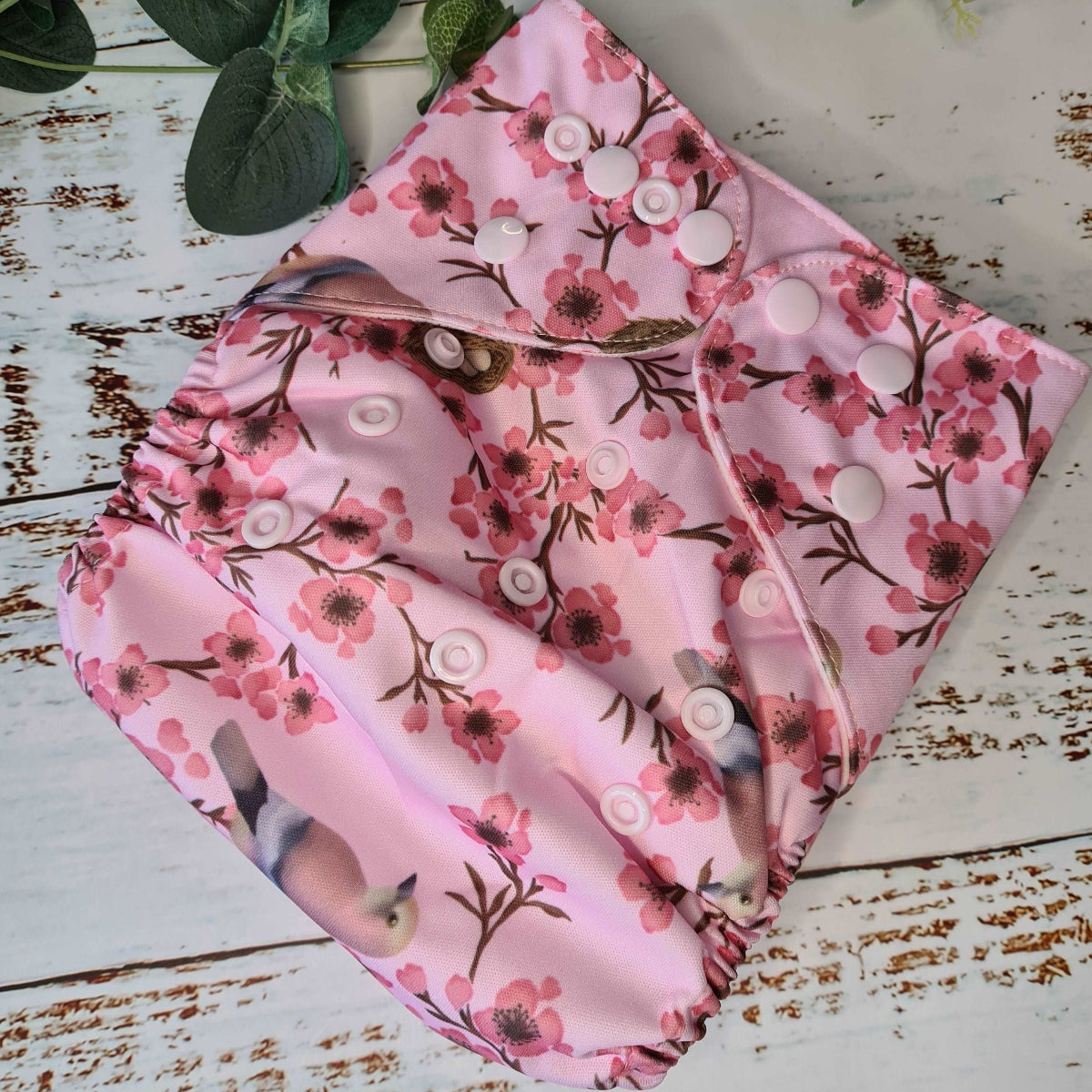 A photograph of cloth diaper pocket nappies and hemp boosters, illustrating their eco-friendly and adjustable design. Ideal for baby girls. 