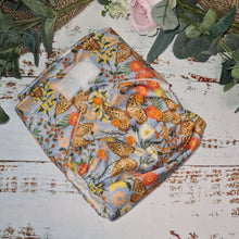 Load image into Gallery viewer, Cloth pocket nappies with hemp boosters displayed neatly, offering a reusable and soft alternative to disposable diapers in a butterfly print
