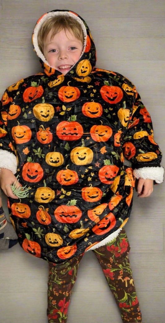 Child wearing pumpkin fleece hooded blanket