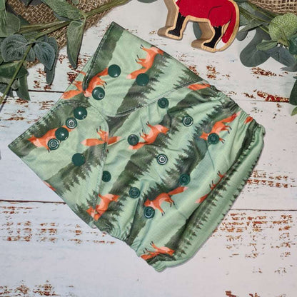 A picture of cloth diaper pocket nappies in a fox print a green and economical choice for baby care