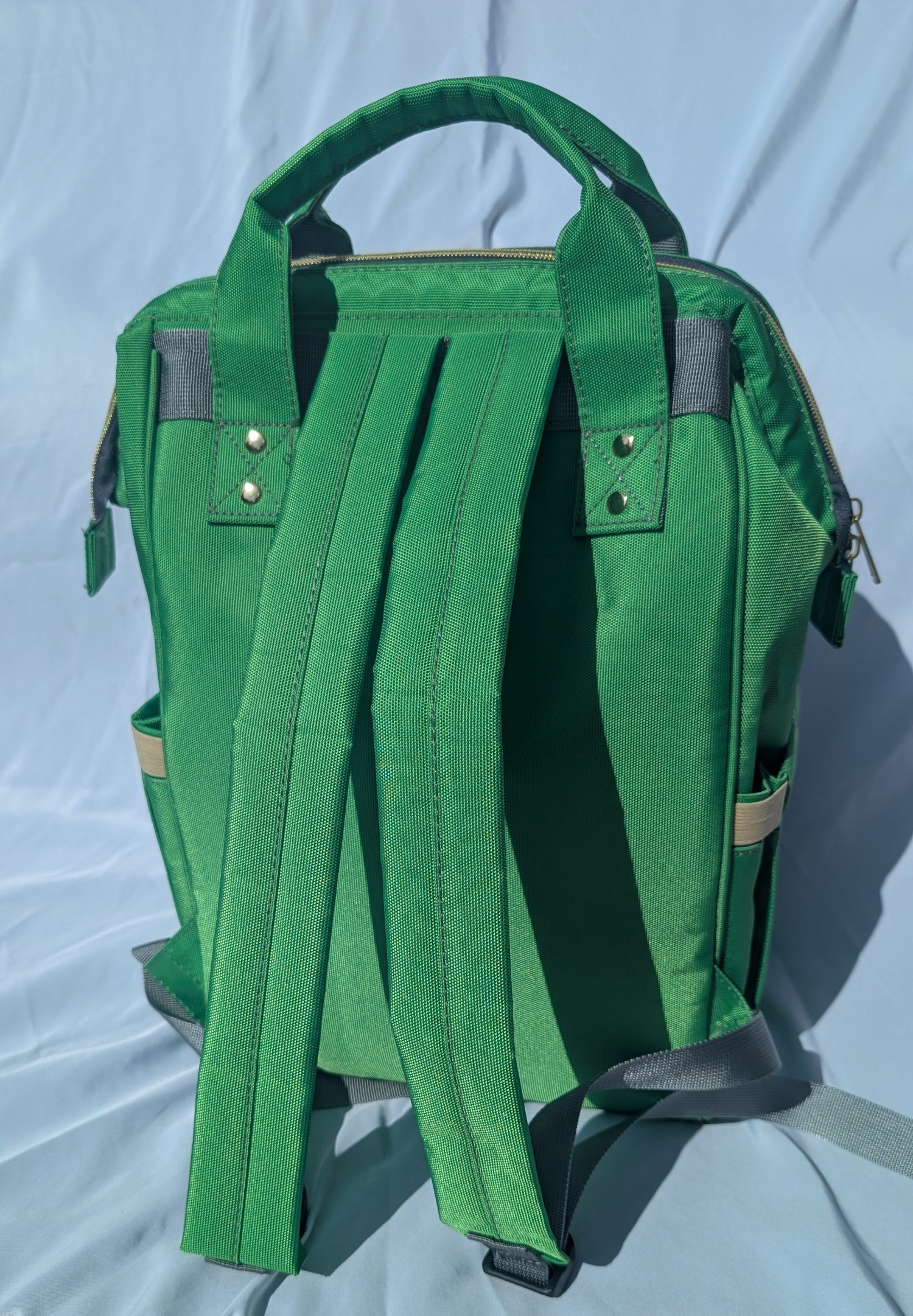Green backpack on a light background
