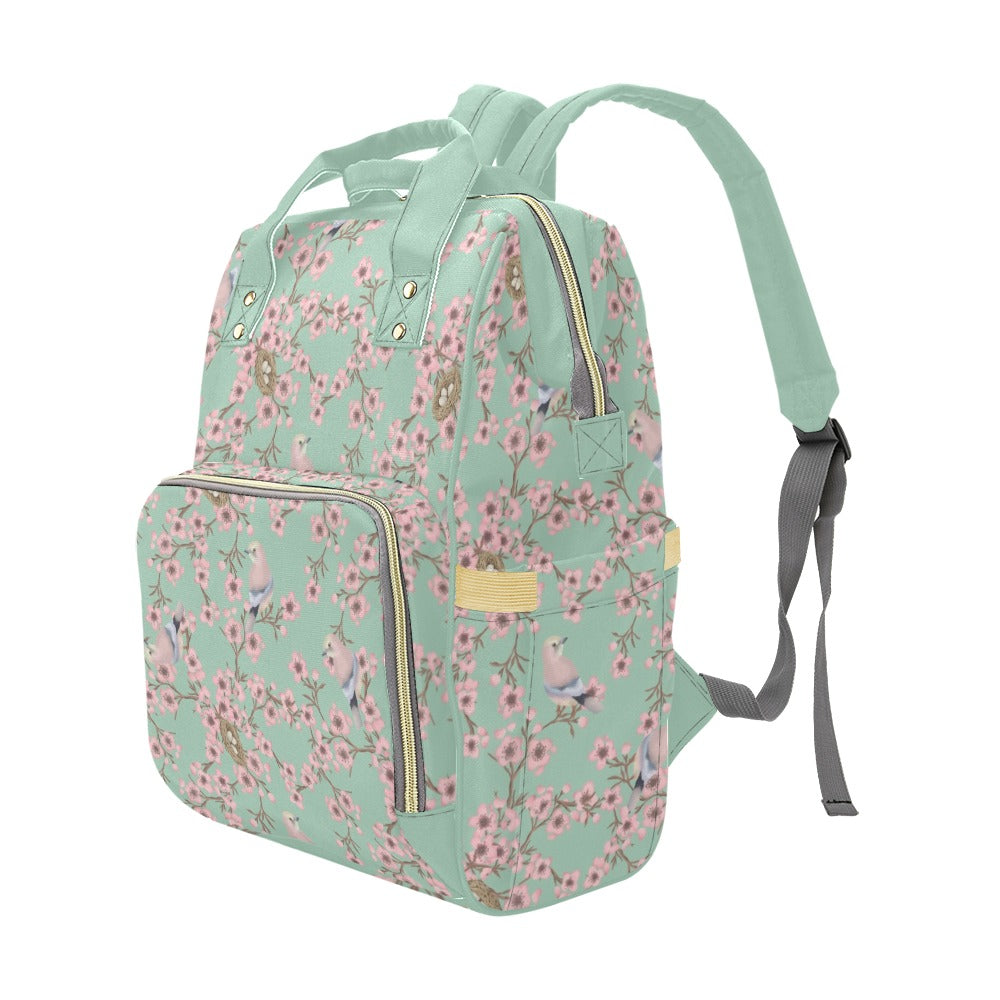Floral-patterned backpack with a light green background