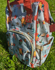 Floral-patterned baby changing backpack on grass