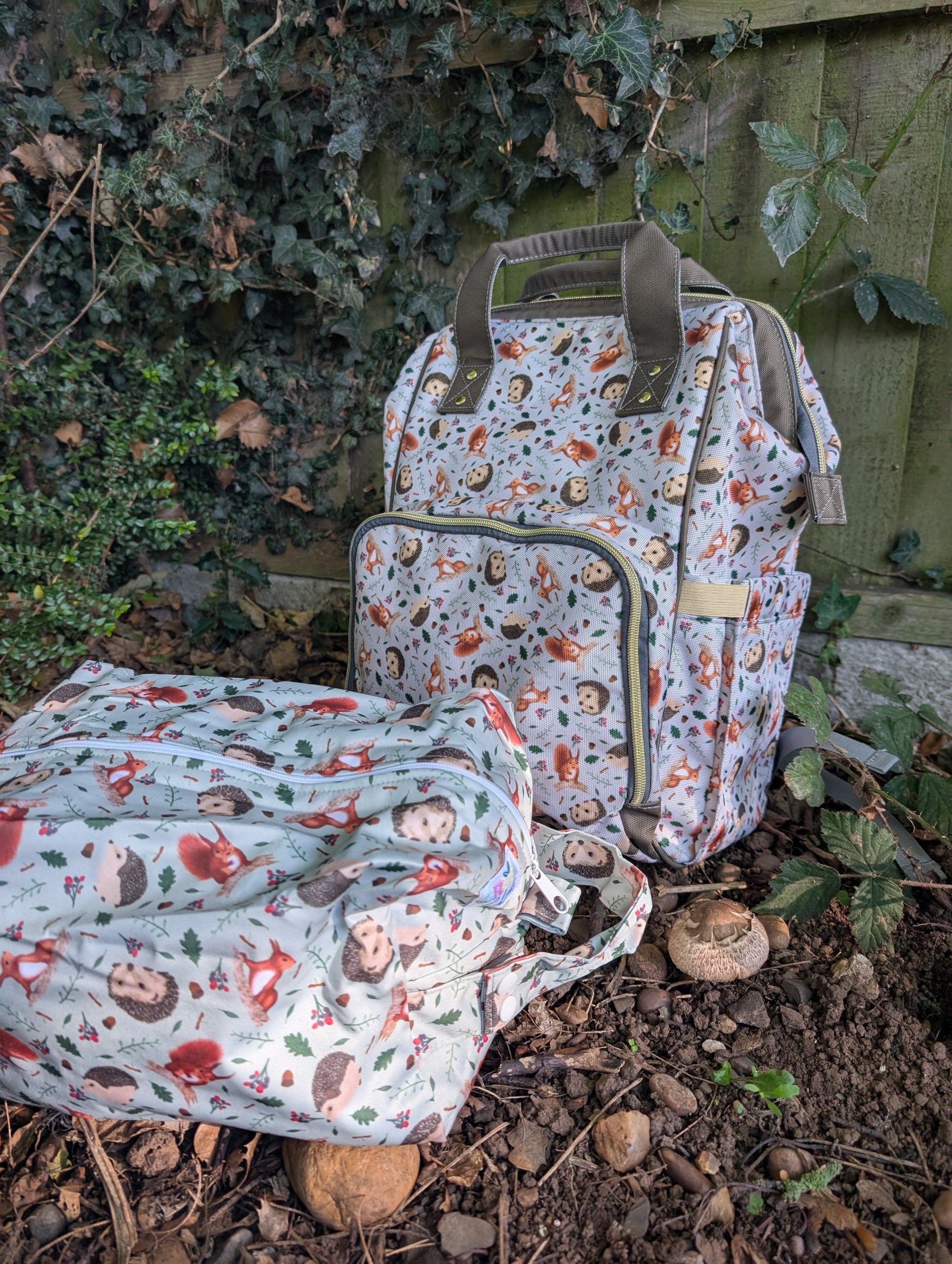 Two patterned bags on the ground with a natural background