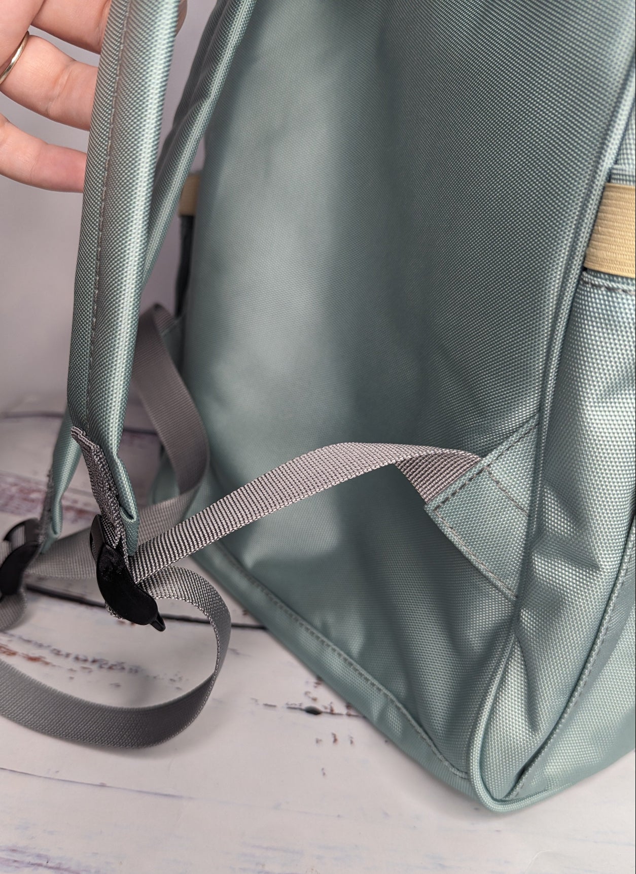 Straps of a Green Cheeks baby changing bag