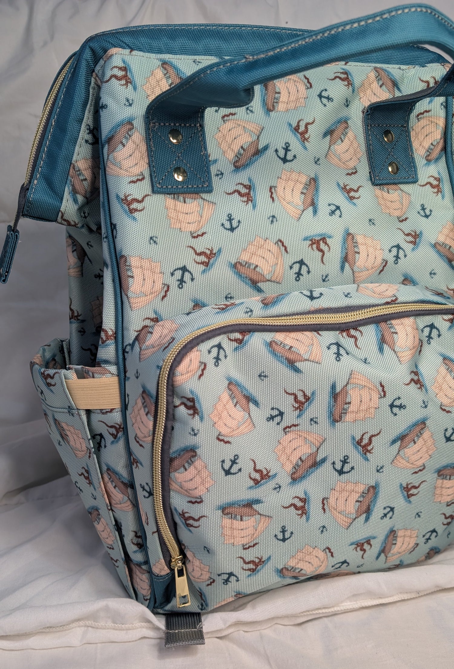 Diaper bag with nautical pattern on a white surface