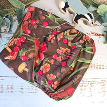 Load image into Gallery viewer, An overhead view of cloth pocket nappies and hemp boosters, an excellent choice for eco-conscious parents in a brown mushroom print
