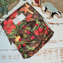 Load image into Gallery viewer, An overhead view of cloth pocket nappies and hemp boosters, an excellent choice for eco-conscious parents, natural undergrowth scene is depicted
