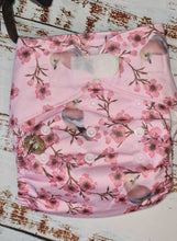 Load image into Gallery viewer, A photograph of cloth diaper pocket nappies and hemp boosters, illustrating their eco-friendly and adjustable design. features pink blossom and jay birds. 
