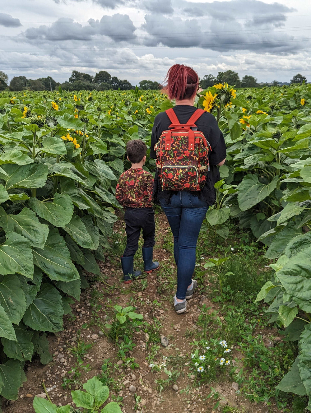 OUt & About with the Green Cheeks Changing Bag in a sunflower field 