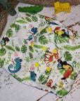 A close-up image of cloth pocket nappies with toucans, highlighting their adjustable snaps and sustainable materials.