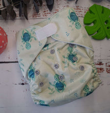 Load image into Gallery viewer, An image of cloth pocket nappies with hemp boosters neatly arranged on a flat surface. The nappies are made of soft, colorful fabric with elastic leg cuffs and snaps for adjustable sizing. The hemp boosters are slim inserts made from natural fibers, designed to enhance absorbency. This eco-friendly diapering option provides reusable and sustainable comfort for babies
