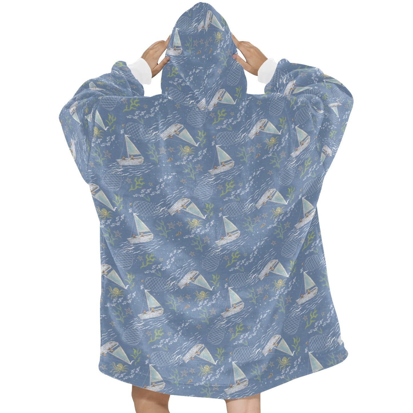 A warm and comfortable fleece hooded blanket in a calming blue boats pattern, similar to the Oodie, perfect for wrapping up and staying snu