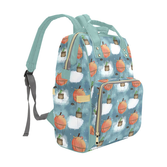 Side view of baby nappy backpack showing stretchy bottle pocket and colourful peach balloon design. A playful and practical everyday bag