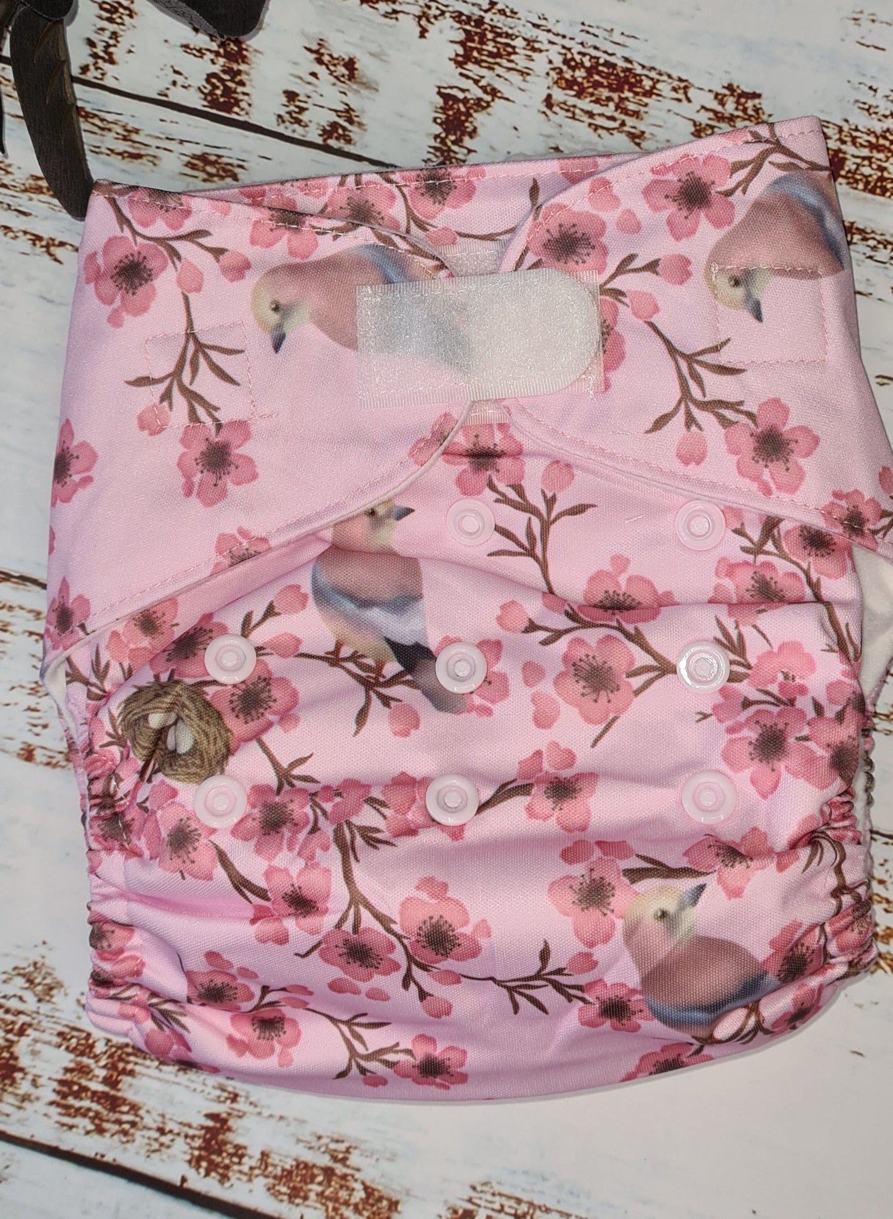 A photograph of cloth diaper pocket nappies and hemp boosters, illustrating their eco-friendly and adjustable design.