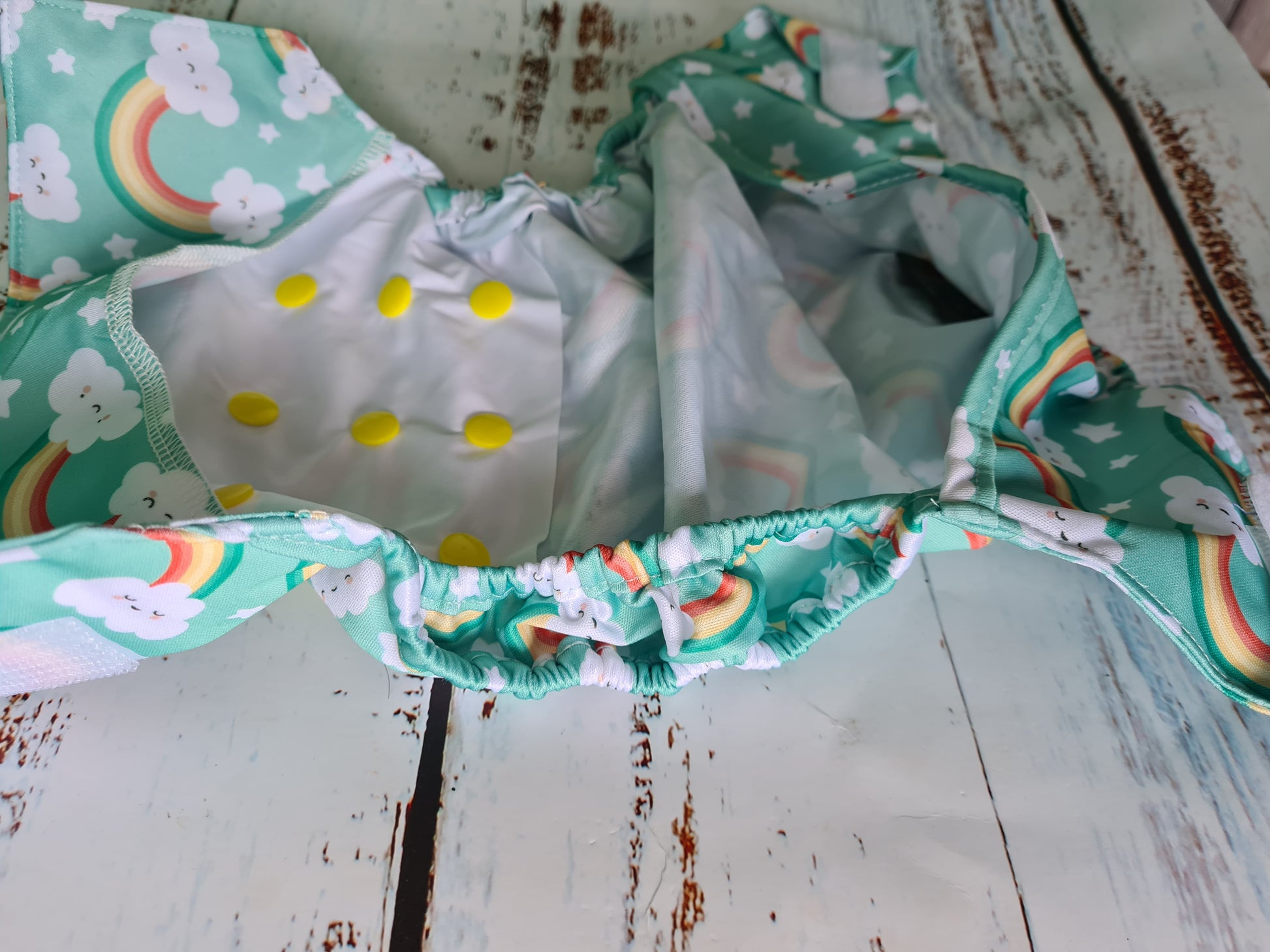 Adjusting a cloth nappy for a snug and secure fit, promoting eco-conscious diapering practices
