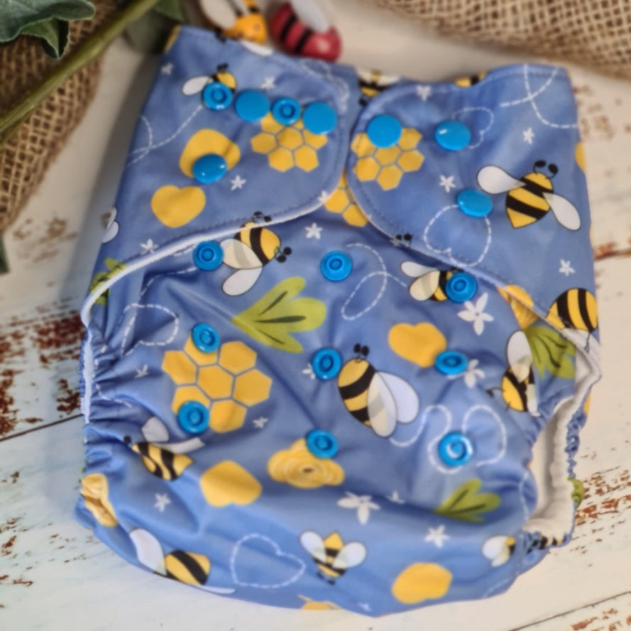 A photo of cloth pocket nappies featuring hemp boosters, showcasing an eco-friendly diapering choice with colorful, reusable fabrics