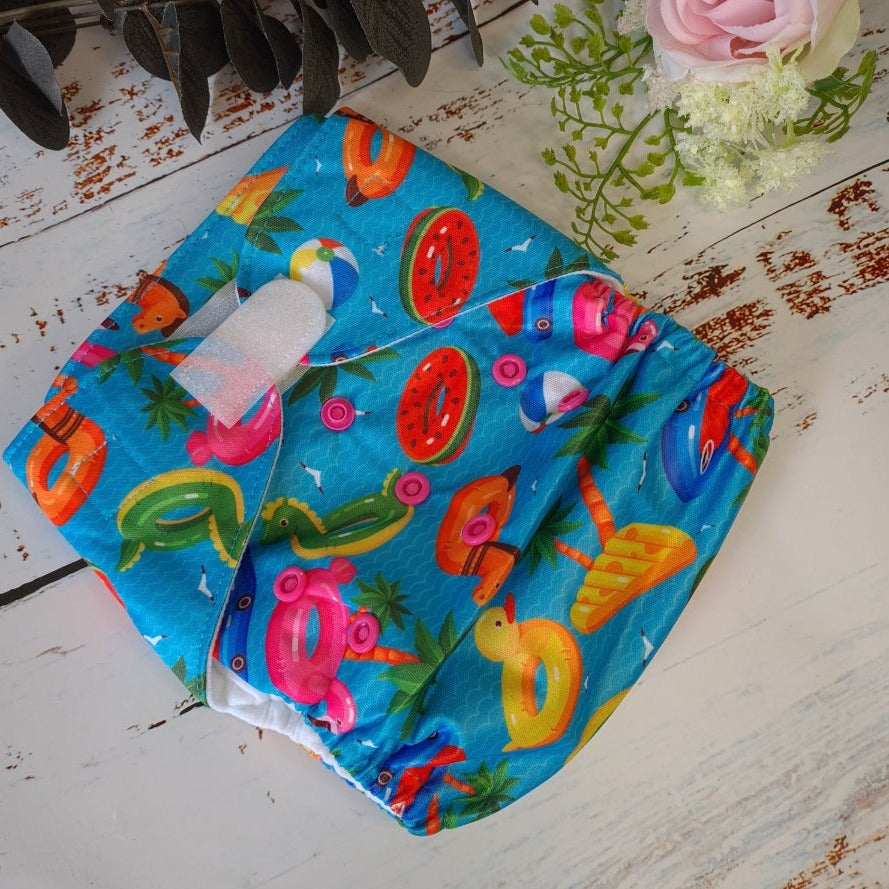 Cloth pocket nappies with hemp boosters in various vibrant colors, providing a sustainable way to keep babies comfortable and dry