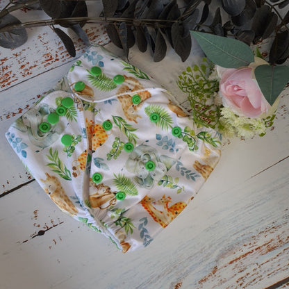 Cloth pocket nappies with hemp boosters in various vibrant colors, providing a sustainable way to keep babies comfortable and dry featuring cute sleeping animals. 