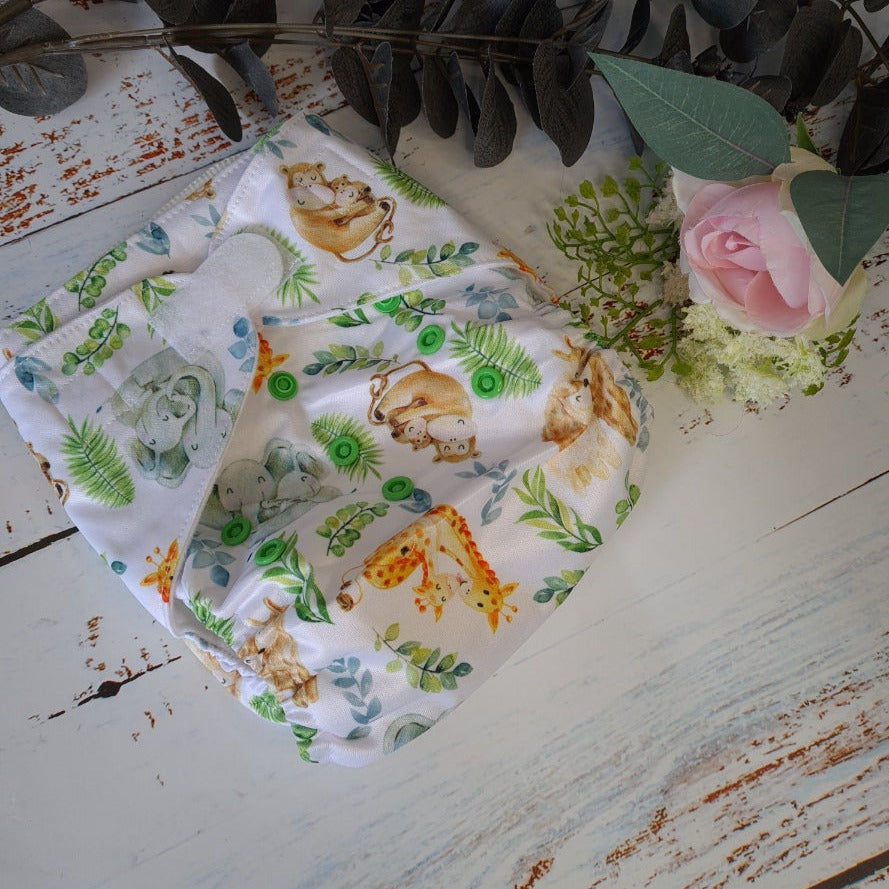 Cloth pocket nappies with hemp boosters in various vibrant colors, providing a sustainable way to keep babies comfortable and dry with velcro fasten