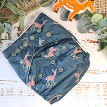 Indlæs billede til gallerivisning A visual of cloth pocket nappies and hemp boosters, demonstrating their snug fit and natural fiber absorbency.
